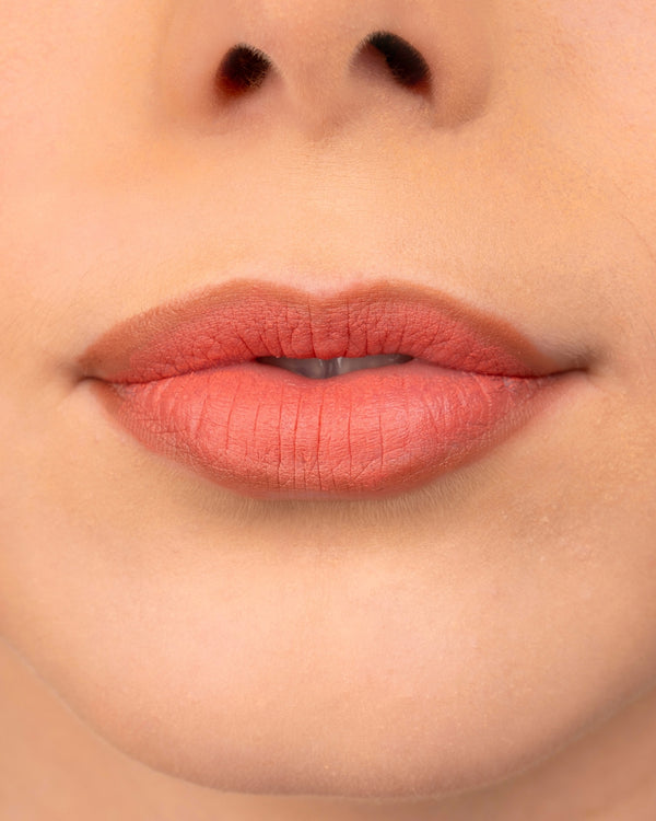 Close-up of lips wearing Ohana&K Vegan and Cruelty-Free Matte Lipstick, showing vibrant, smooth matte finish in Burnt Coral.