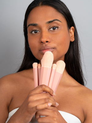 Model using the Ohana&K cruelty-free Brush Set for a flawless makeup finish with soft synthetic bristles, perfect for powder and liquid products.