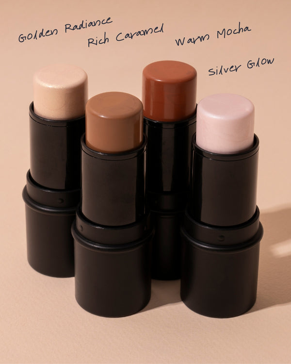 Ohana&K Highlighter & Contour Stick in four shades: Silver Glow, Golden Radiance, Warm Mocha, and Rich Caramel, displayed in a natural setting.