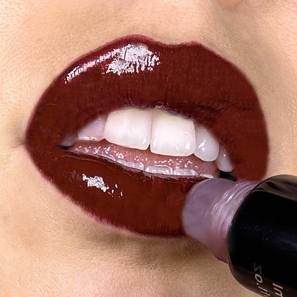 Close-up of lips wearing Ohana&K Vegan and Cruelty-Free Lip Gloss in Smoked Paprika, showing a warm red glossy finish that enhances natural lip color.